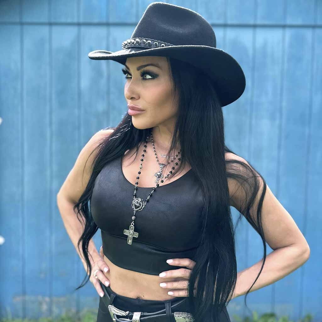 Black sacred heart rosary necklace shown worn by Carla Harvey.