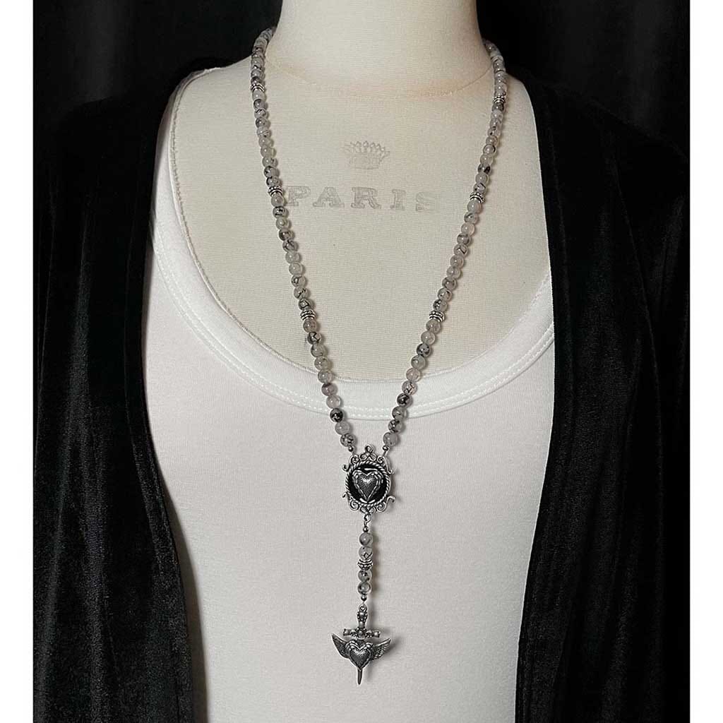 Styled photo showing the beaded rosary necklace in full length by rock my wings.