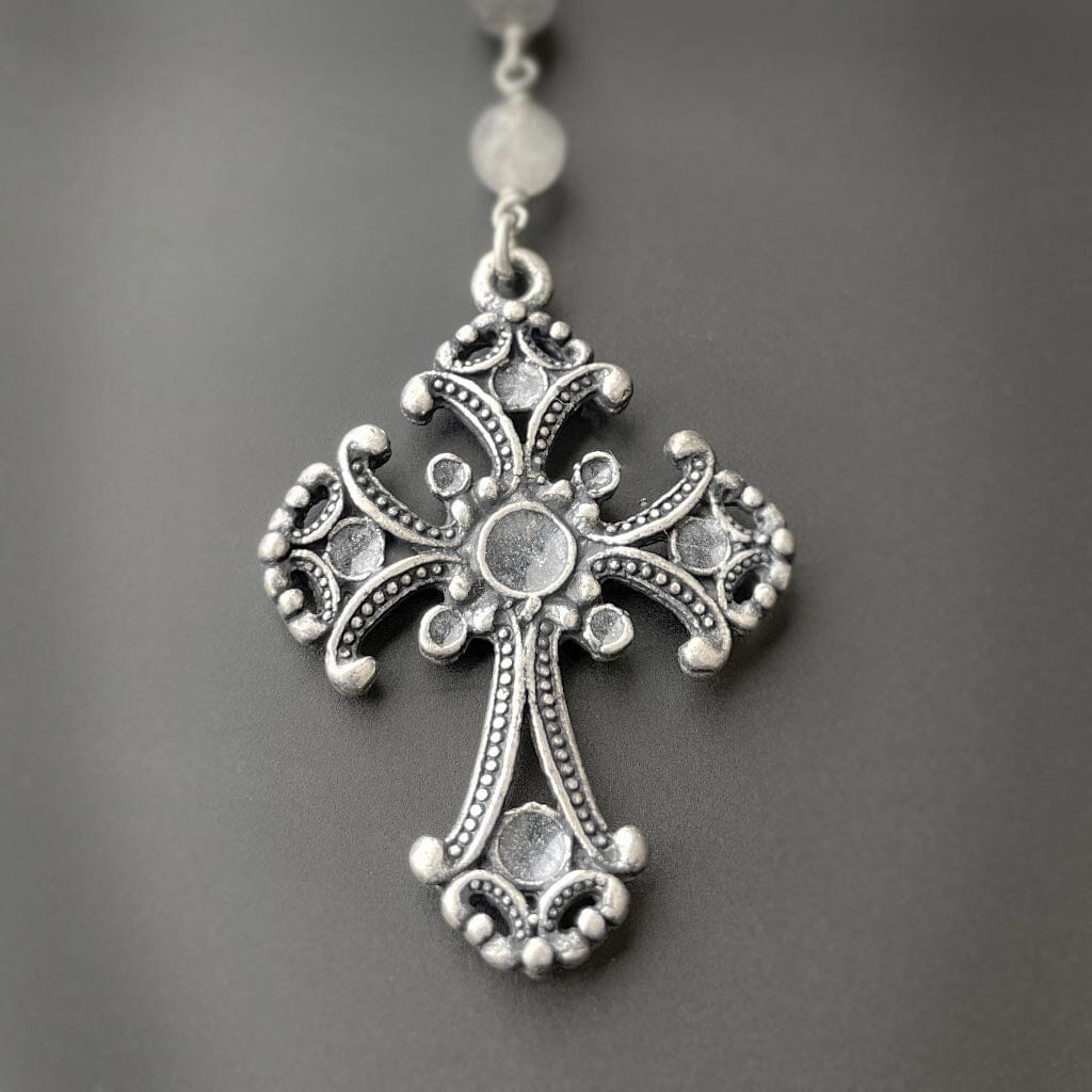 close up view of the cross on the gray rosary necklace for women by rock my wings