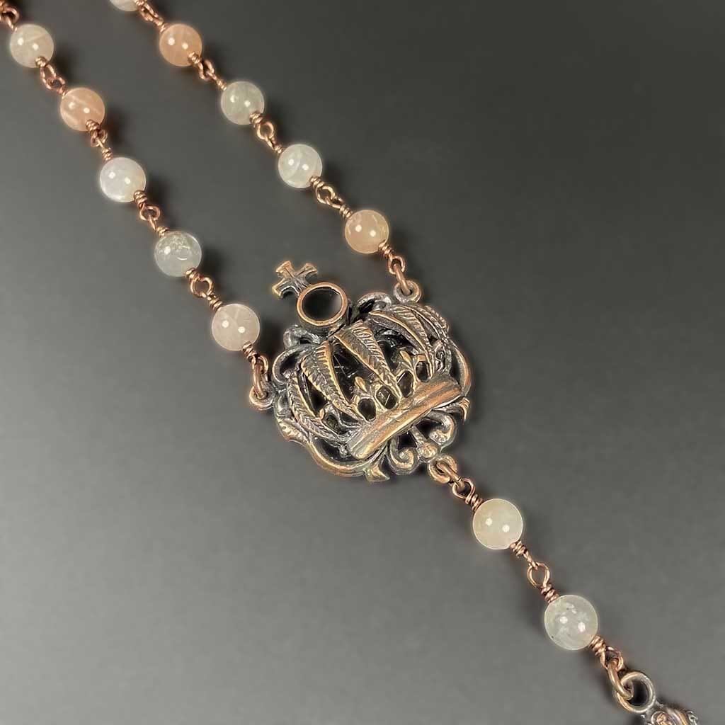 Close up of beaded crown rosary necklace with antique copper finish for women