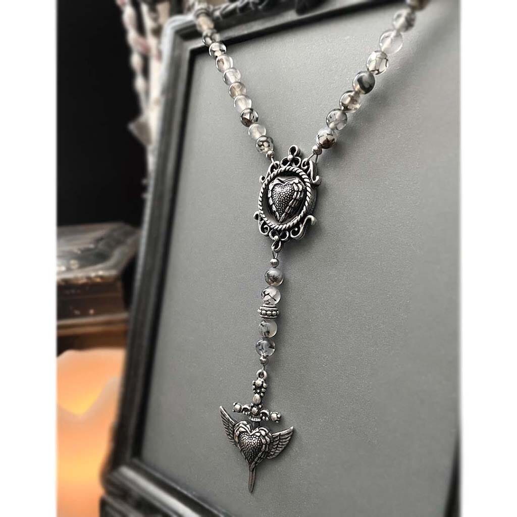 Close up showing the heart center and dagger drop on the beaded rosary necklace by Rock my Wings