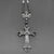 Close up of silver cross with black accents on the beaded rosary necklace
