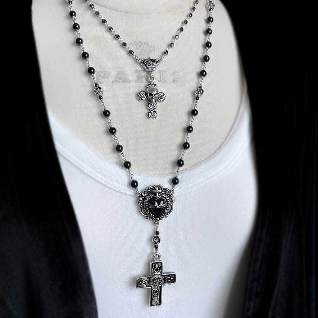 image showing the skull and rose rosary necklace styled with a longer rosary necklace
